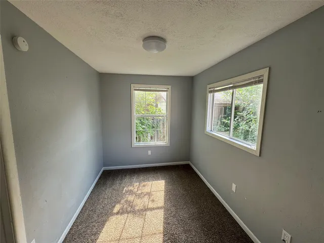 a view of room with hardwood floor and window