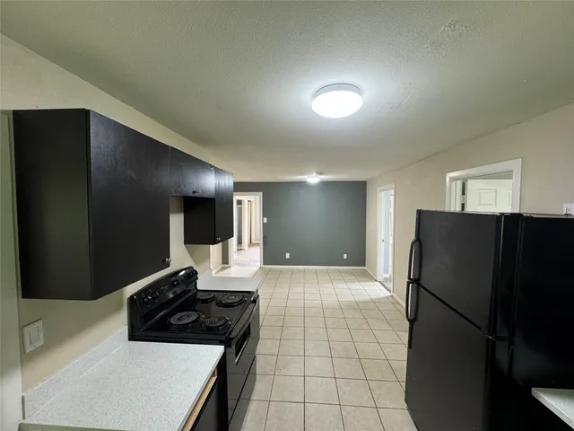 a kitchen with a refrigerator and a stove