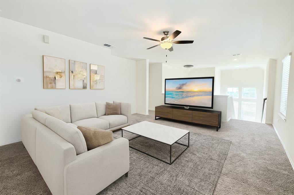 1336 Morning View Road Georgetown, TX 78628 - Photo 24 of 40 A well-lit loft area provides a flexible living space with vaulted ceilings and soft carpeting.