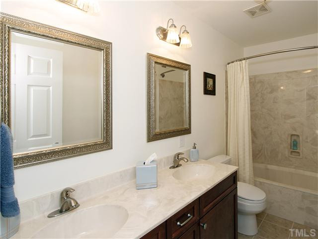 4301 Hickory Ridge Drive Raleigh, NC 27609 - Photo 20 of 25 You'd never believe that this used to be a dark, dingy bathroom. Tile, vanity, hardware, lighting mirrors, tub, toilet - all brand new! Bathroom