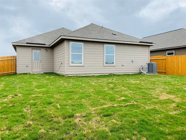 a front view of house with yard and garage
