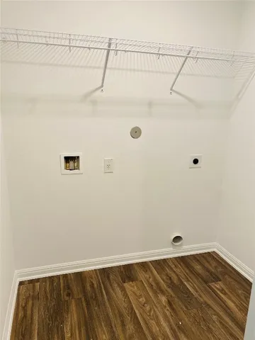 a view of a room with wooden floor