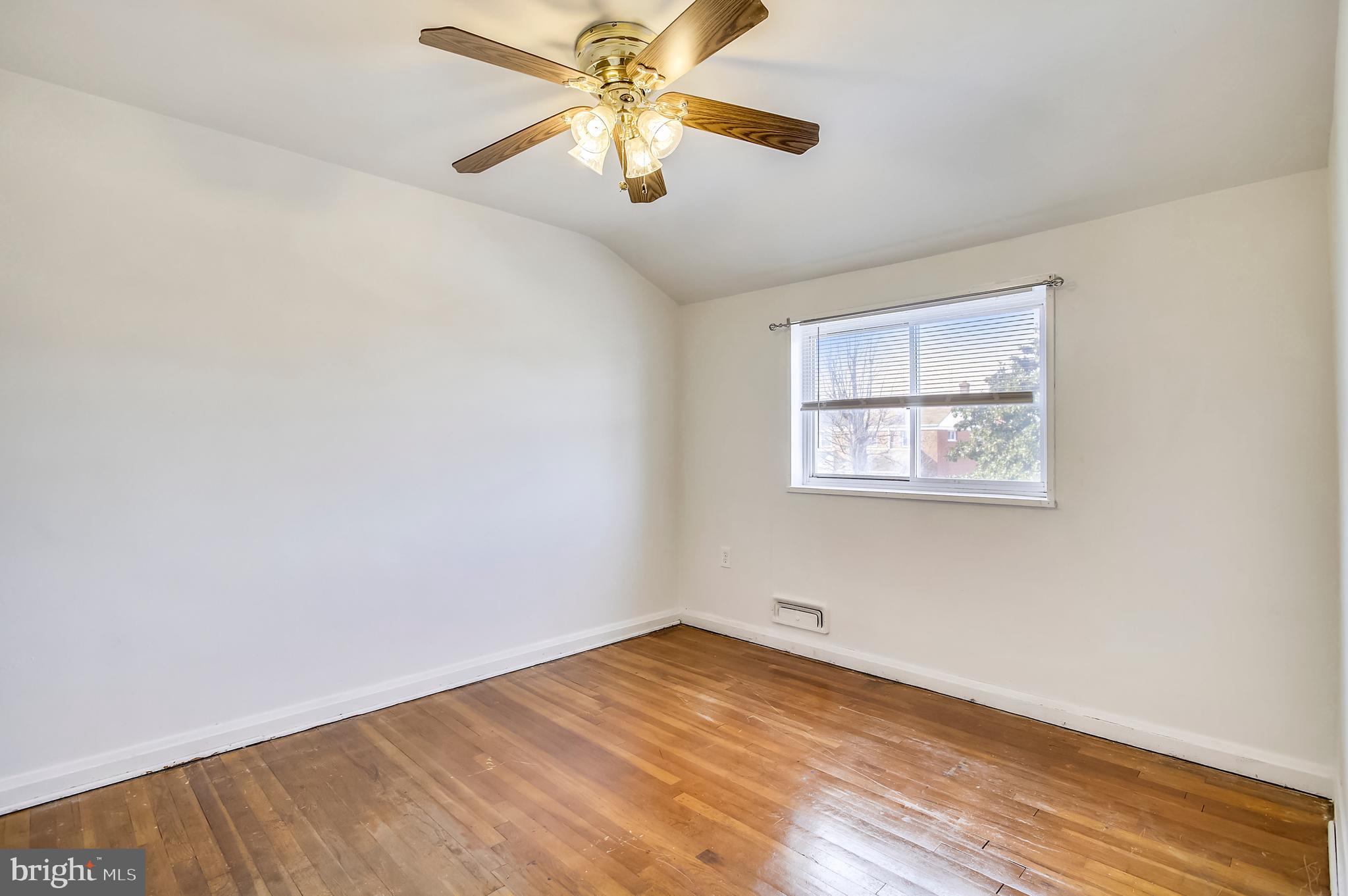 2019 Holborn Road Baltimore, MD 21222 - Photo 16 of 42 an empty room with wooden floor and windows