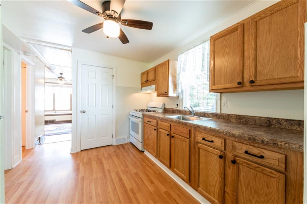 222 Reis Run Road Pittsburgh, PA 15237 - Photo 15 of 25 a kitchen with stainless steel appliances granite countertop a sink cabinets and wooden floor