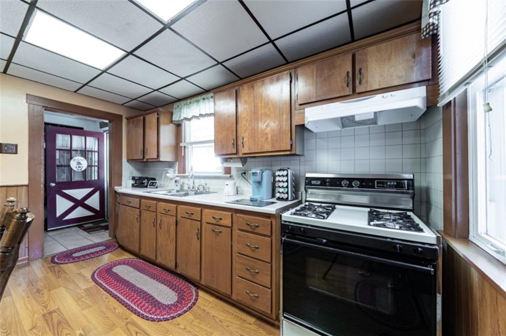 222 Reis Run Road Pittsburgh, PA 15237 - Photo 4 of 25 a kitchen with a stove and a sink