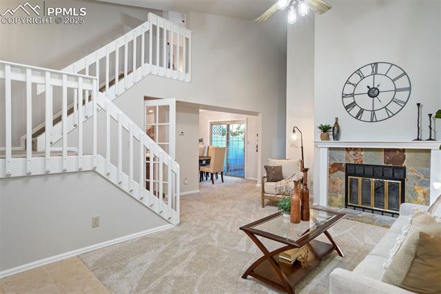 18 Rising Sun Terrace Colorado Springs, CO 80921 - Photo 3 of 50 Soaring ceilings, slate-accented fireplace, and dramatic staircase created an airy, welcoming living space with fresh paint and new carpet.
