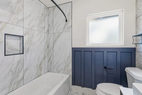 a bathroom with a toilet and a bathtub