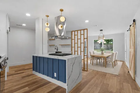 a kitchen with sink cabinets and wooden floor