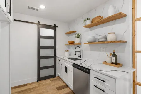 a kitchen with stainless steel appliances a sink and cabinets