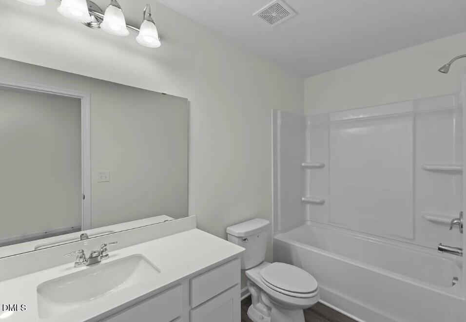 660 Essex Road Nashville, NC 27856 - Photo 11 of 22 a bathroom with a sink toilet vanity and shower