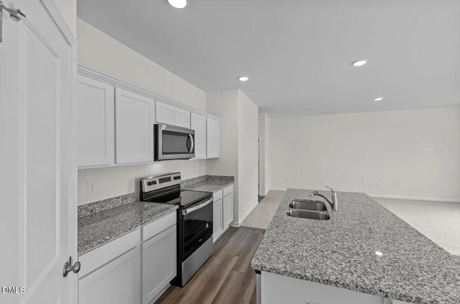 660 Essex Road Nashville, NC 27856 - Photo 5 of 22 a kitchen with stainless steel appliances granite countertop a sink stove and microwave