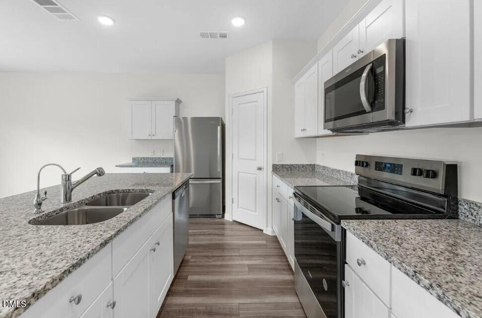 660 Essex Road Nashville, NC 27856 - Photo 6 of 22 a kitchen with stainless steel appliances granite countertop a sink stove and refrigerator