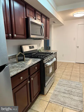 a kitchen with a sink a stove a microwave and cabinets