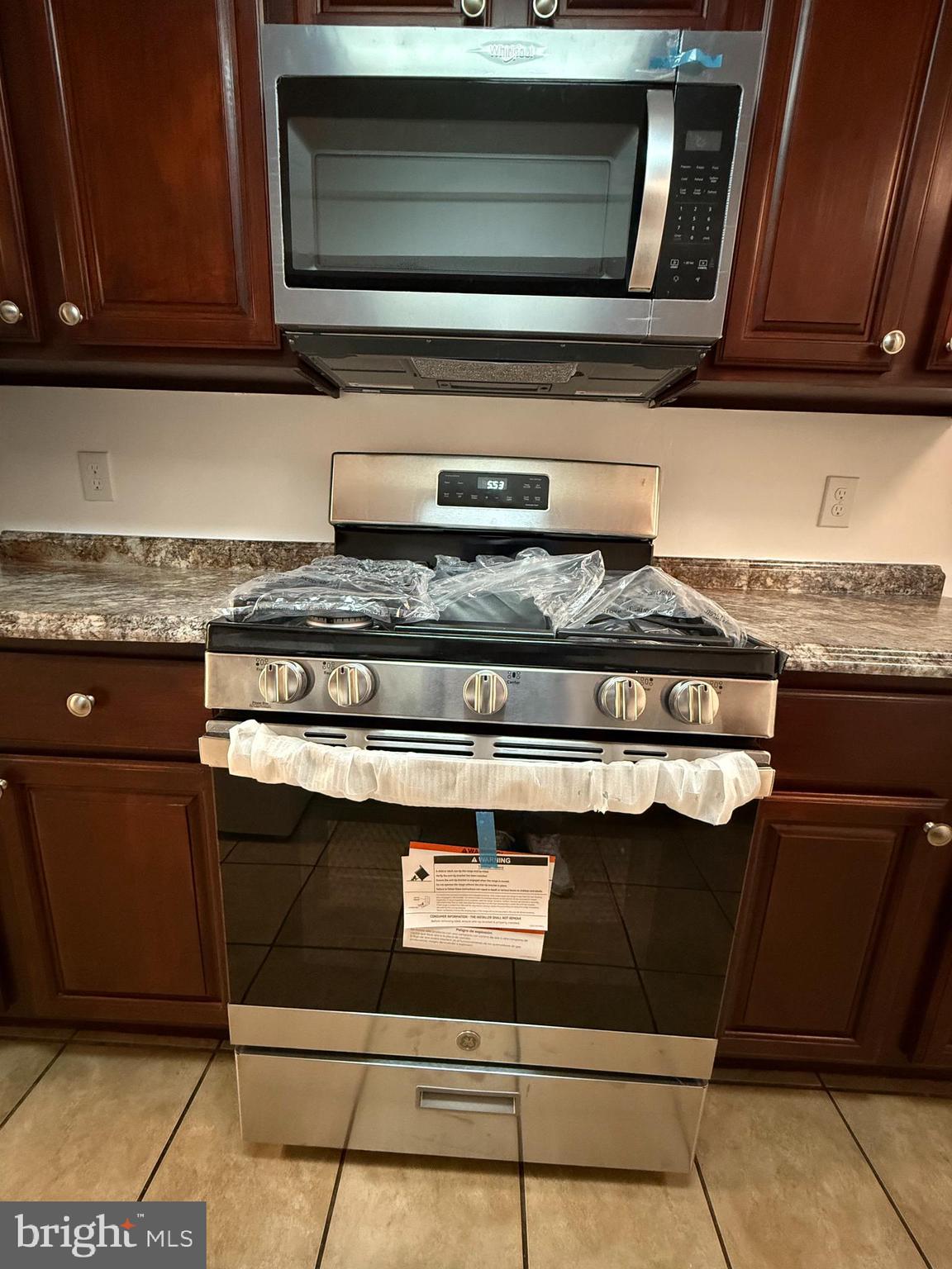 10244 Prince Place, Unit 21T3 Upper Marlboro, MD 20774 - Photo 16 of 64 a stove top oven sitting inside of a kitchen