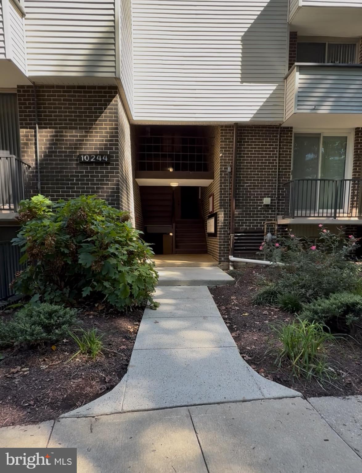 10244 Prince Place, Unit 21T3 Upper Marlboro, MD 20774 - Photo 2 of 64 a front view of a house with garden