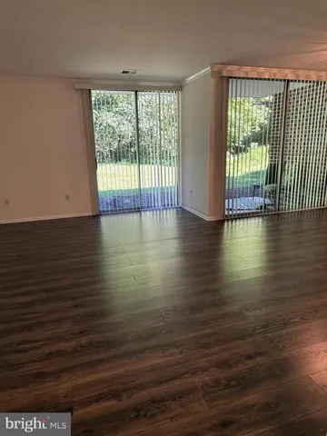 a view of a room with wooden floor