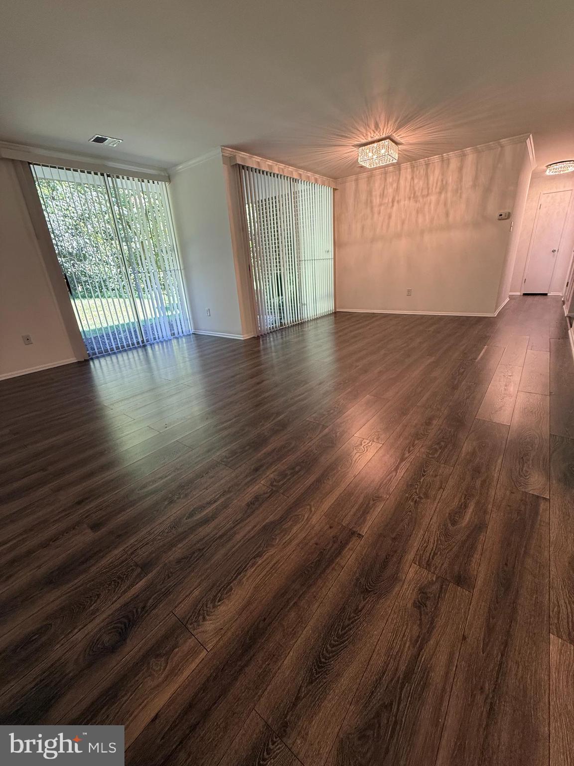 10244 Prince Place, Unit 21T3 Upper Marlboro, MD 20774 - Photo 23 of 64 an empty room with wooden floor and windows