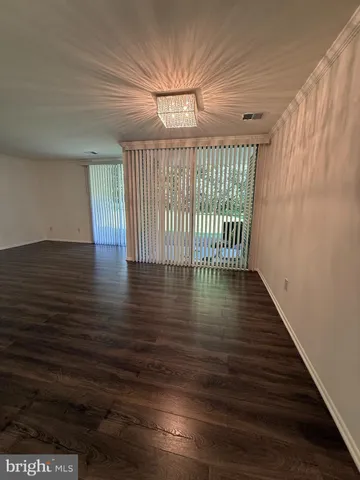 a bedroom with bed and wooden floor