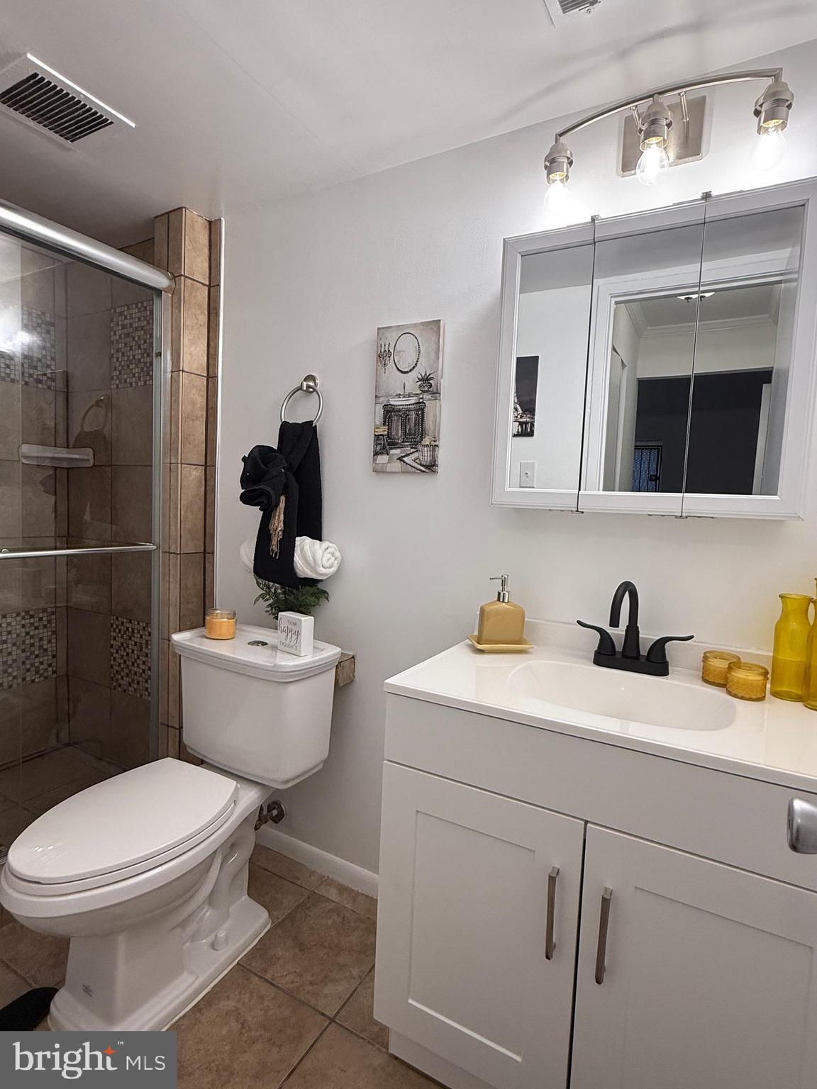 10244 Prince Place, Unit 21T3 Upper Marlboro, MD 20774 - Photo 44 of 64 a bathroom with a toilet a sink and mirror