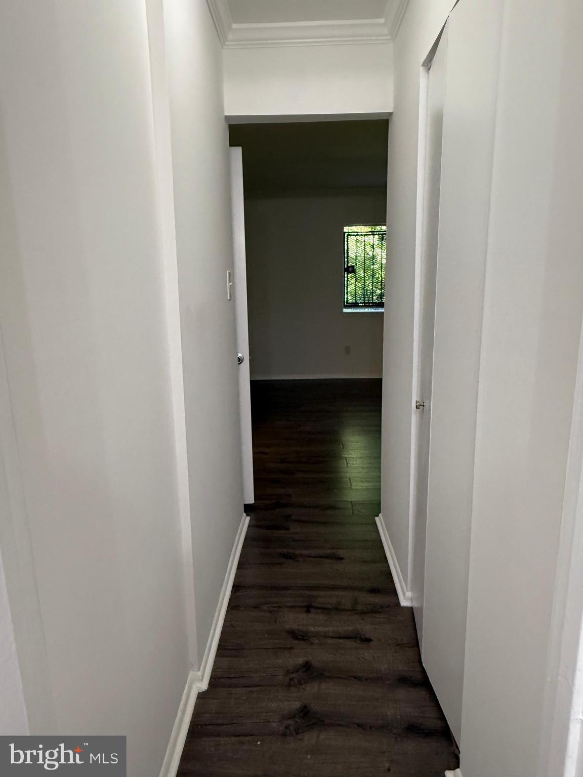 10244 Prince Place, Unit 21T3 Upper Marlboro, MD 20774 - Photo 49 of 64 a view of a hallway with wooden floor and a window