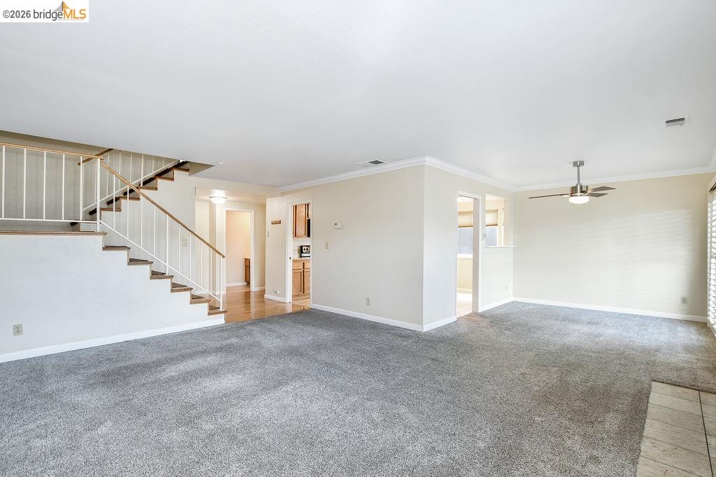 184 Pelican Loop Pittsburg, CA 94565 - Photo 11 of 56 a view of a big room with staircase and white walls