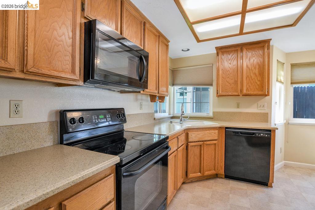 184 Pelican Loop Pittsburg, CA 94565 - Photo 15 of 56 a kitchen with stainless steel appliances granite countertop a sink stove and microwave