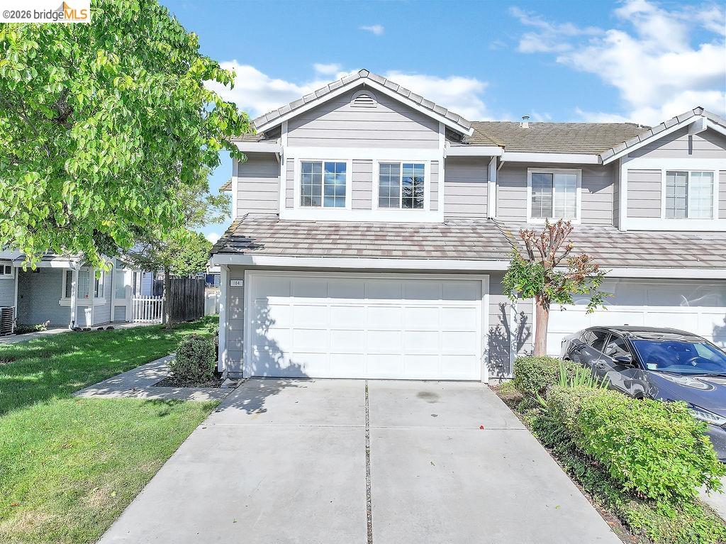 184 Pelican Loop Pittsburg, CA 94565 - Photo 4 of 56 a front view of a house with a yard and garage