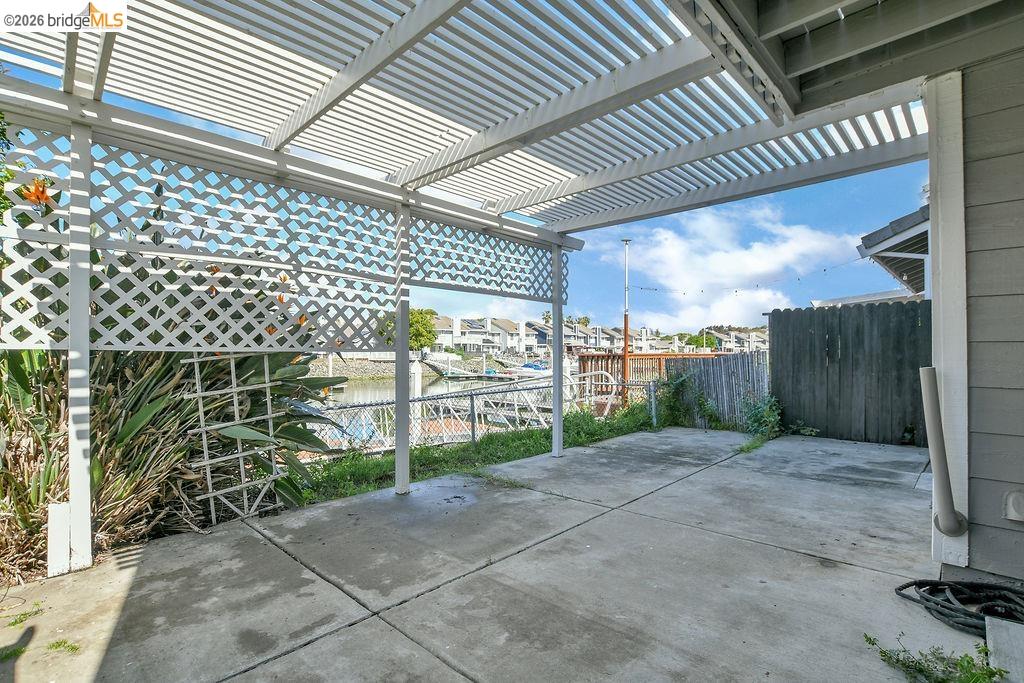 184 Pelican Loop Pittsburg, CA 94565 - Photo 44 of 56 Fenced backyard with a patio area, a water view, a pergola, and a residential view