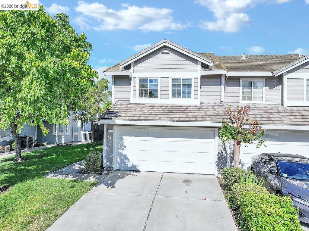 184 Pelican Loop Pittsburg, CA 94565 - Photo 5 of 56 a front view of a house with a yard and garage