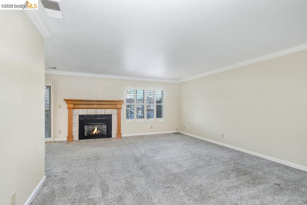 184 Pelican Loop Pittsburg, CA 94565 - Photo 10 of 56 a view of an empty room with a fireplace and a window