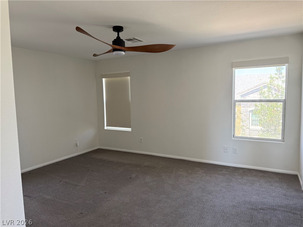 1141 Cathedral Ridge Street Henderson, NV 89052 - Photo 44 of 77 This spacious bedroom offers ample natural light and a comfortable atmosphere for rest and relaxation.
