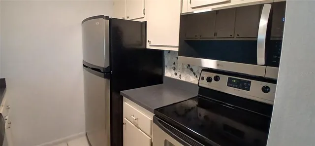 a kitchen with a stove and a microwave