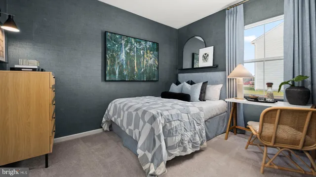 a bedroom with a bed chair and window