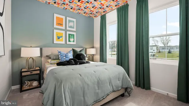 a bed sitting in a bedroom next to a window