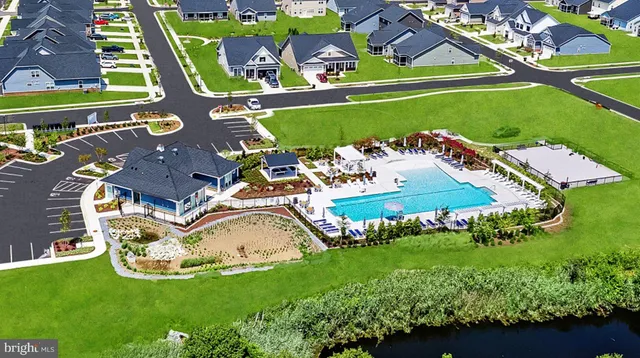 an aerial view of a house with a swimming pool outdoor seating and yard