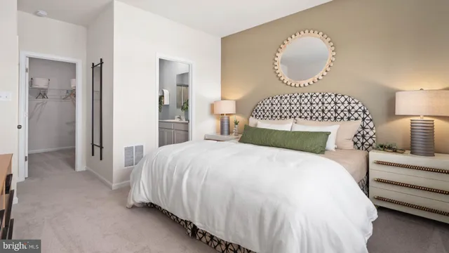 a bedroom with bed and a chandelier