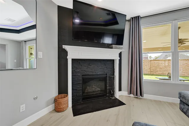 a living room with a fireplace and a flat screen tv