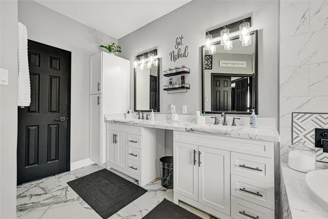 a bathroom with a double vanity sink and mirror
