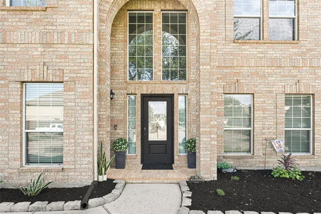 a front view of a brick house with a outdoor space