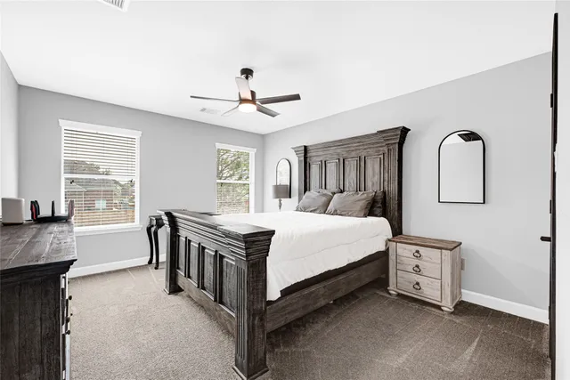 a bathroom with a sink a toilet a mirror a vanity and shower