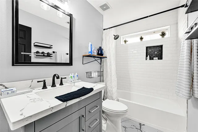 a bed room with a bed and a ceiling fan