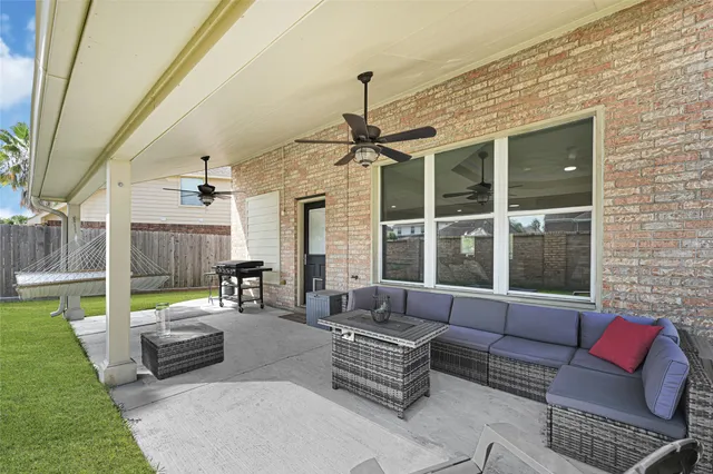 a front view of a house with swimming pool having outdoor seating
