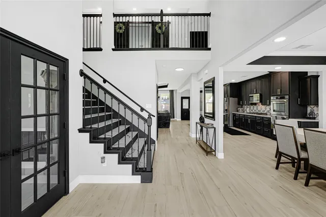 a view of entryway and hall with wooden floor