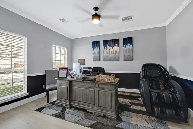 a view of a workspace with furniture and a window
