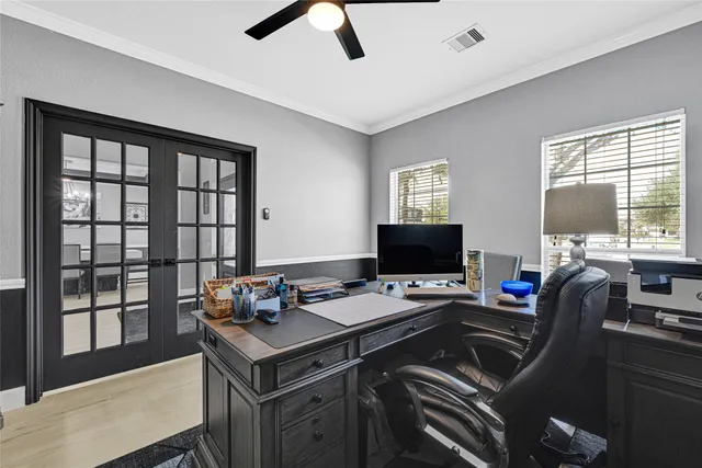 a view of a workspace with furniture and a window