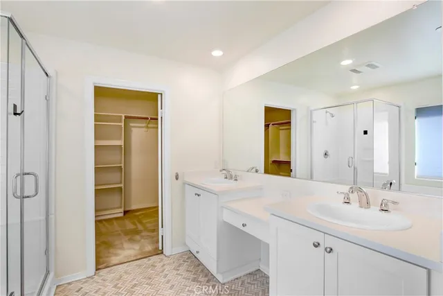 a bathroom with a sink double vanity and a mirror