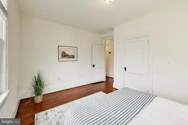 a bedroom with a bed and a potted plant