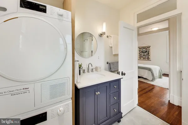 a en suite bathroom with a granite countertop sink and a mirror