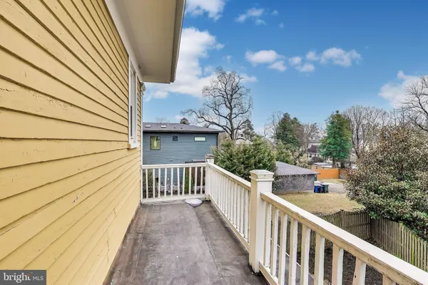 a view of a balcony with wooden fence and floor