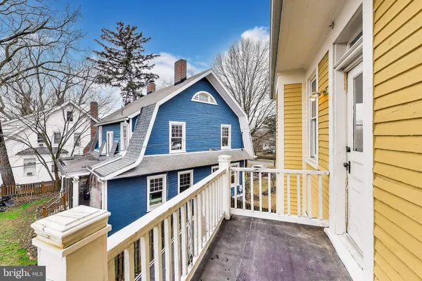 a view of a house with wooden fence and two windows